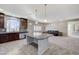 Open-concept kitchen with granite countertops, stainless steel appliances, and seamless flow to the living area and backyard views at 6773 Goose Watch Ct, Las Vegas, NV 89139
