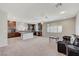 Open concept living space featuring a spacious kitchen with a large island and a cozy seating area with a leather sofa at 6773 Goose Watch Ct, Las Vegas, NV 89139