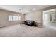 Spacious living room featuring neutral carpet, modern lighting, and shuttered windows at 6773 Goose Watch Ct, Las Vegas, NV 89139