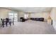 Large living area with a sliding glass door to a balcony, offering plenty of seating at 6773 Goose Watch Ct, Las Vegas, NV 89139