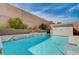 Private backyard featuring a refreshing pool, lush landscaping, and a block wall for added privacy at 6929 Benson Ferry St, Las Vegas, NV 89149