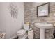 Modern half-bathroom features a pedestal sink, custom finishes, and is perfect for guests at 6929 Benson Ferry St, Las Vegas, NV 89149