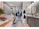Beautiful bathroom featuring a soaking tub, dual vanities, and patterned tile at 6929 Benson Ferry St, Las Vegas, NV 89149