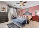 Cozy bedroom features a sitting area, ceiling fan, and neutral decor at 6929 Benson Ferry St, Las Vegas, NV 89149