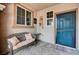 Inviting front porch featuring a cozy bench, stylish decor, and a secure front door at 6929 Benson Ferry St, Las Vegas, NV 89149