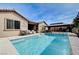 Beautiful backyard oasis with a sparkling pool, built-in waterfall, and a covered outdoor kitchen area at 6929 Benson Ferry St, Las Vegas, NV 89149