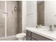 Modern bathroom features gray vanity with marble countertop and tiled walk-in shower at 700 Carnegie St # 3214, Henderson, NV 89052