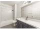 Bright bathroom with a gray vanity and a tub-shower combination with marble tile at 700 Carnegie St # 3214, Henderson, NV 89052