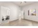 Minimalist bedroom with wood floors leading to an adjoining bathroom and a bright window at 700 Carnegie St # 3214, Henderson, NV 89052