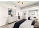 Staged bedroom with a dresser, mirrored closet, and a view of an ensuite bathroom at 700 Carnegie St # 3214, Henderson, NV 89052