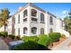 Well-maintained condo with a stucco exterior, arched windows, and manicured landscaping at 700 Carnegie St # 3214, Henderson, NV 89052