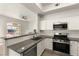 Open kitchen layout with stainless steel appliances, sleek countertops, and white cabinets at 700 Carnegie St # 3214, Henderson, NV 89052