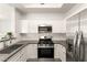 Updated kitchen boasts stainless steel appliances, sleek countertops, and white cabinetry at 700 Carnegie St # 3214, Henderson, NV 89052
