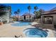 Community pool with a spa and a covered area that leads to the pool with lounge chairs on the pool deck at 700 Carnegie St # 3214, Henderson, NV 89052