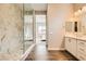 Open bathroom layout with marble shower, wood-style flooring, and bright vanity lighting at 728 Omaggio Pl, Henderson, NV 89011