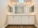 Bathroom with double vanity sinks, modern lighting, and a view of the walk-in shower at 728 Omaggio Pl, Henderson, NV 89011