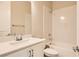 Bathroom features a shower-tub combo, single sink vanity, white cabinets, and tile flooring at 728 Omaggio Pl, Henderson, NV 89011