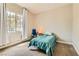 Cozy bedroom with a large window, comfortable carpet, and neutral walls at 728 Omaggio Pl, Henderson, NV 89011