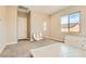 Spacious bedroom with carpet flooring, a large window and a door leading to an adjacent room at 728 Omaggio Pl, Henderson, NV 89011