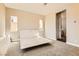 Bright bedroom with neutral carpet, baseboards, and a minimal white bed frame, and natural light at 728 Omaggio Pl, Henderson, NV 89011
