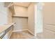 Walk-in closet with shelving and carpet, adjacent to the ensuite bathroom and its marble shower at 728 Omaggio Pl, Henderson, NV 89011