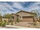 Beautiful single-story home featuring a stone facade, two-car garage, and a professionally landscaped front yard with brick driveway at 728 Omaggio Pl, Henderson, NV 89011