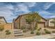 Single-story home boasts stone accents, a two-car garage, brick driveway, and an enclosed front yard with stone steps at 728 Omaggio Pl, Henderson, NV 89011