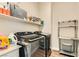 Well-organized laundry room featuring modern Samsung washer and dryer and ample storage shelving at 728 Omaggio Pl, Henderson, NV 89011