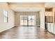 Open-concept living area with sleek hardwood floors and sliding glass doors to the backyard at 728 Omaggio Pl, Henderson, NV 89011