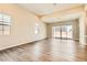 Inviting open-plan living room with hardwood floors and sliding door to the backyard at 728 Omaggio Pl, Henderson, NV 89011