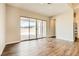 Bright living room features hardwood floors and sliding doors to the backyard patio at 728 Omaggio Pl, Henderson, NV 89011