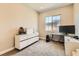 Home office with large window, neutral walls and carpet and a simple, modern desk at 728 Omaggio Pl, Henderson, NV 89011