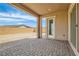 Covered patio with brick flooring, offering views of the backyard, and a slider to the home at 728 Omaggio Pl, Henderson, NV 89011