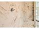 Tiled shower with mosaic tile flooring and shower head, complemented with marble-look tile walls at 728 Omaggio Pl, Henderson, NV 89011