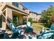 Backyard with patio and seating area, green grass, and second story balcony at 8224 Opal Falls St, North Las Vegas, NV 89085