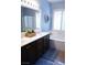 Serene bathroom with dual vanity sinks, a soaking tub, and plantation shutters at 8224 Opal Falls St, North Las Vegas, NV 89085