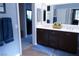 A bathroom with double sinks and access to a walk in closet, providing convenience and functionality at 8224 Opal Falls St, North Las Vegas, NV 89085