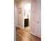 Neutral powder room featuring wood floors, dark vanity, framed mirror and patterned rug at 8224 Opal Falls St, North Las Vegas, NV 89085