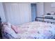 Comfortable bedroom featuring a floral comforter, a spacious closet, and natural light at 8224 Opal Falls St, North Las Vegas, NV 89085