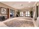 Spacious clubhouse with neutral-colored walls, tile flooring, arched doorways, and large decorative area rugs at 8224 Opal Falls St, North Las Vegas, NV 89085