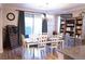 Elegant dining room with a chandelier, wood table, and sliding glass door at 8224 Opal Falls St, North Las Vegas, NV 89085