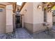 Home exterior showcasing desert landscaping and a wrought iron security gate at 8224 Opal Falls St, North Las Vegas, NV 89085