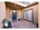 Inviting front porch featuring a blue door, tiled flooring, and seating area at 8224 Opal Falls St, North Las Vegas, NV 89085