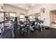Well-equipped gym featuring various exercise machines, a large mirror, and plenty of natural light at 8224 Opal Falls St, North Las Vegas, NV 89085
