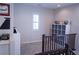 Upstairs hallway with built-in shelving, window, and modern decor at 8224 Opal Falls St, North Las Vegas, NV 89085