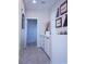 Hallway featuring carpet, a built in white storage cabinet and drawers, and natural lighting at 8224 Opal Falls St, North Las Vegas, NV 89085