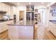 Bright kitchen features an island, stainless steel appliances, and light colored cabinets at 8224 Opal Falls St, North Las Vegas, NV 89085
