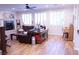 Cozy living room featuring a fireplace, hardwood floors, and large windows at 8224 Opal Falls St, North Las Vegas, NV 89085