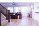 Open living room with hardwood floors, plantation shutters, and a ceiling fan at 8224 Opal Falls St, North Las Vegas, NV 89085