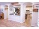 Open floorplan with archways connecting the kitchen and living areas with wood-look floors at 8224 Opal Falls St, North Las Vegas, NV 89085